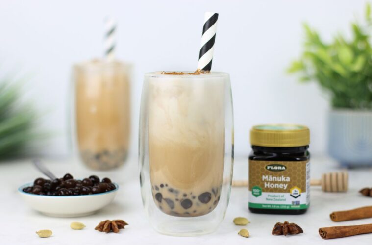 Two healthy, iced chai boba teas and a jar of Flora Manuka Honey